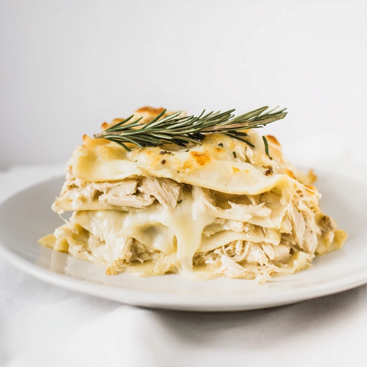 Golden, bubbly Rosemary Chicken Lasagna fresh from the oven, offering a delightful aroma.