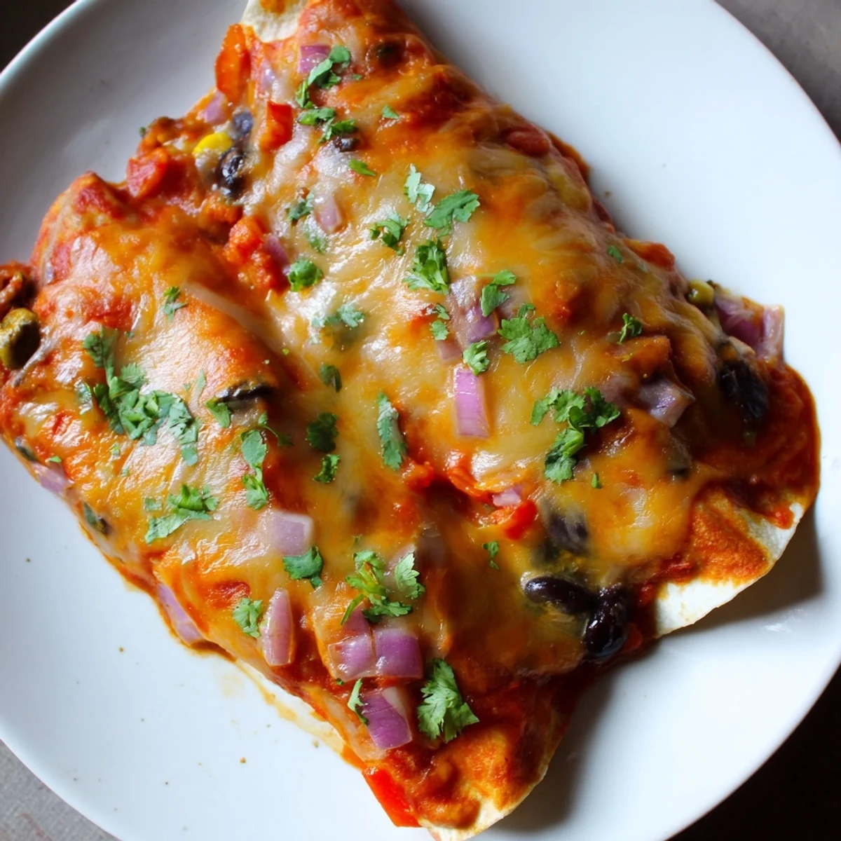 Farmers Market Vegetarian Enchiladas bubbling with cheese and flavorful vegetables, ready to be enjoyed.