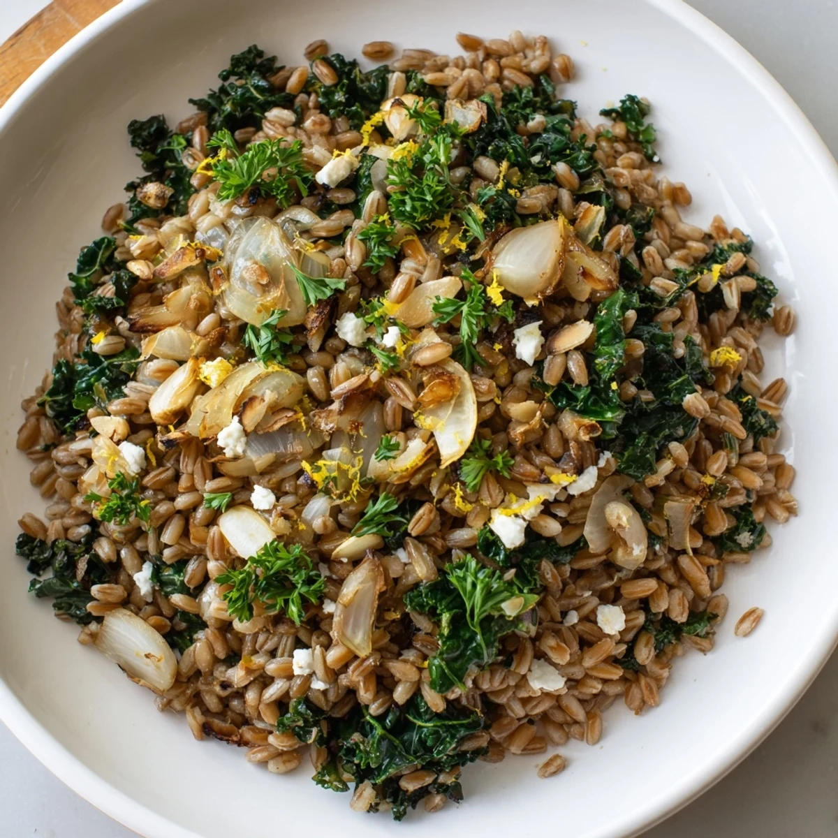 Warm Farro & Greens Pilaf with toasted almonds: a vibrant dish with fluffy farro, and wilted greens.