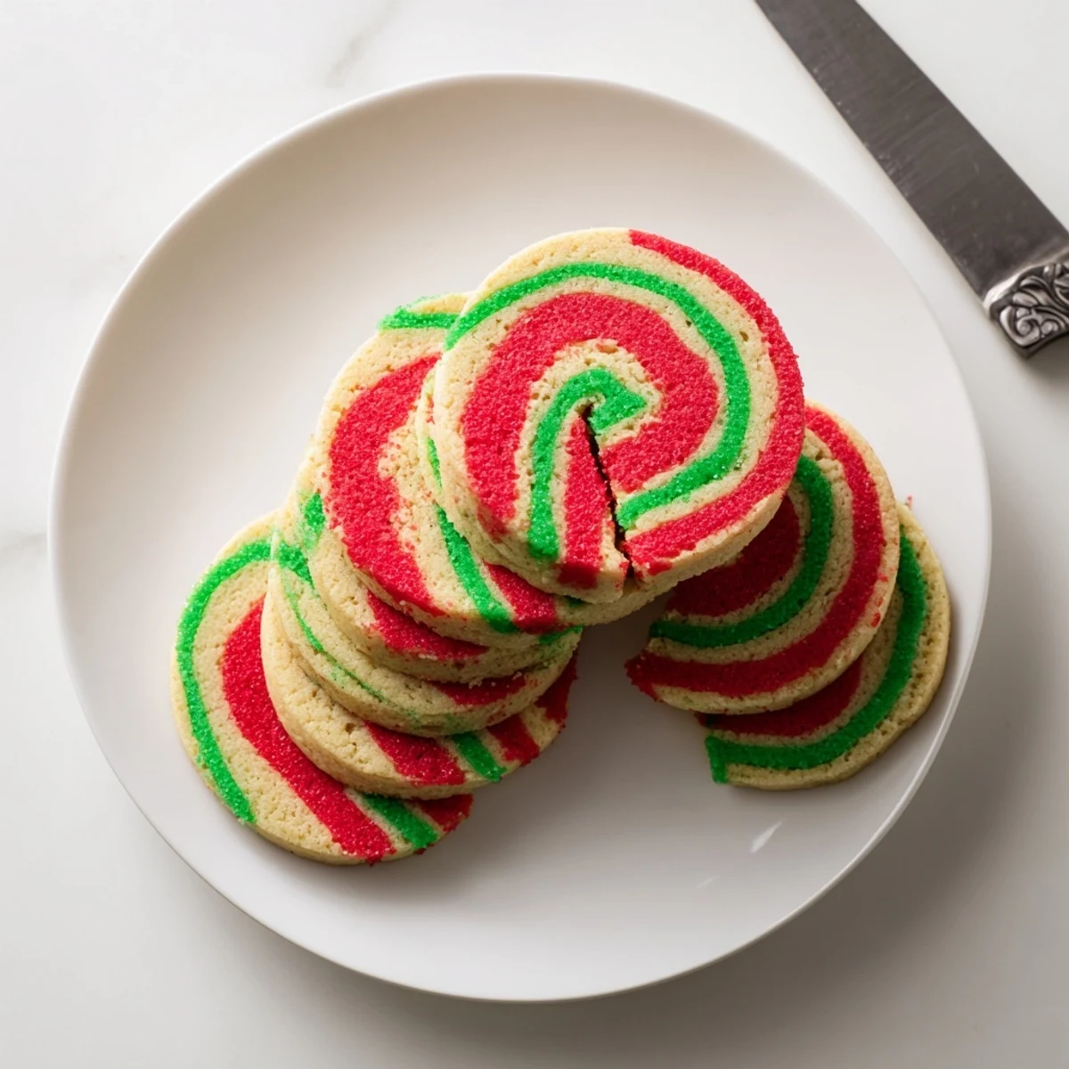 Swirly Holiday Pinwheel Cookies, showing vibrant red and green spirals, ready to share on a festive platter.