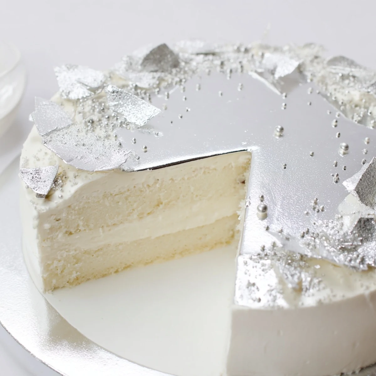 A gleaming Diamond Ring Engagement Cake, layered with delicate mousse and shimmering silver accents.