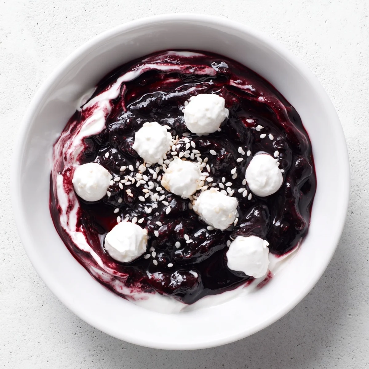 Vibrant Galaxy Spiral dessert: Berry jam swirls on creamy yogurt, sprinkled with sesame "stars".