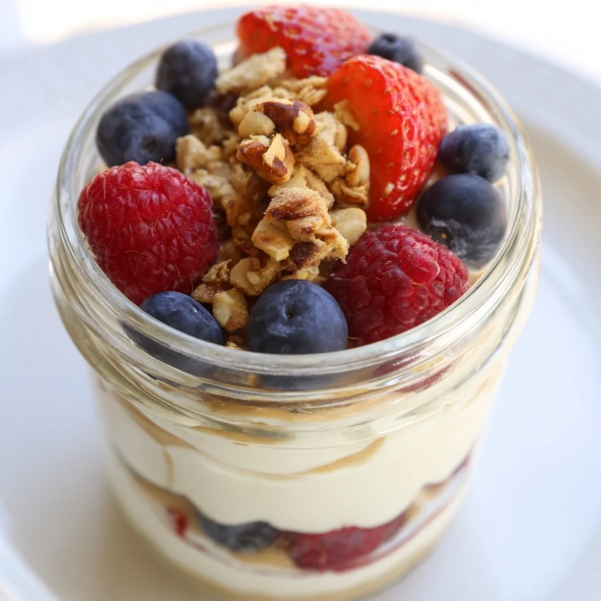 Creamy cashew butter yogurt parfait layered with berries and granola for a delightful breakfast.