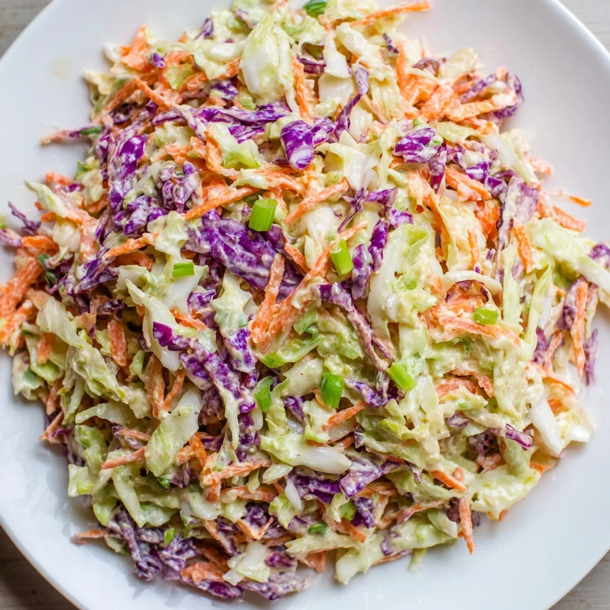 Quick Coleslaw Salad with Creamy Dressing: a vibrant mix of shredded cabbage and carrots, coated in a creamy dressing.