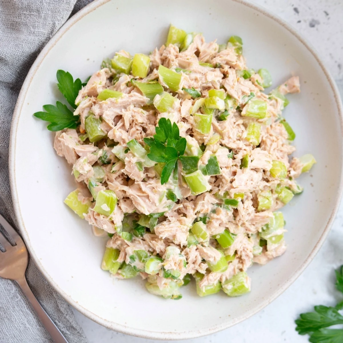 Savory Spicy Zesty Tuna Salad served in crisp lettuce cups, topped with fresh herbs for a light lunch.