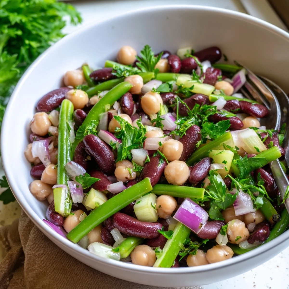 Colorful Three-Bean Salad with tangy dressing, perfect for a summer picnic.
