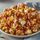 Homemade Peanut Butter Caramel Popcorn Twists cooling, glistening, perfect for movie night snacking.