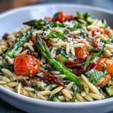 Golden orzo pasta generously tossed with colorful, crisp-tender vegetables and fresh herbs.
