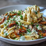 Warm bowl of creamy mushroom pasta, perfect for a cozy, garlic-infused evening meal.