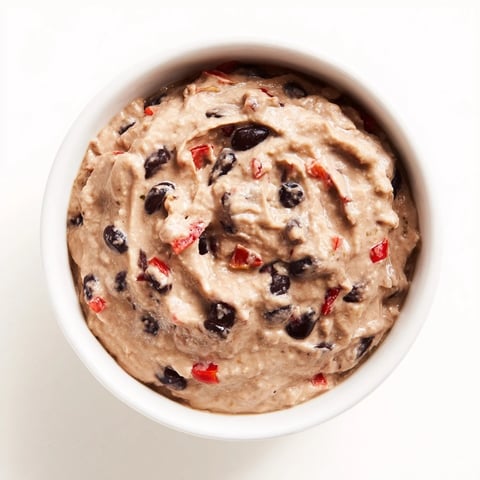 Creamy, vibrant spicy black bean dip served with crispy tortilla chips for dipping fun.