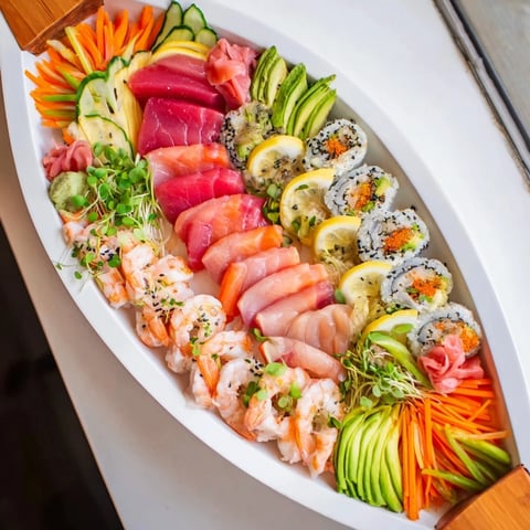 Sail Away Boat-Shaped Sushi Platter beautifully displays a colorful array of sushi rolls and fresh fish, ready to enjoy.