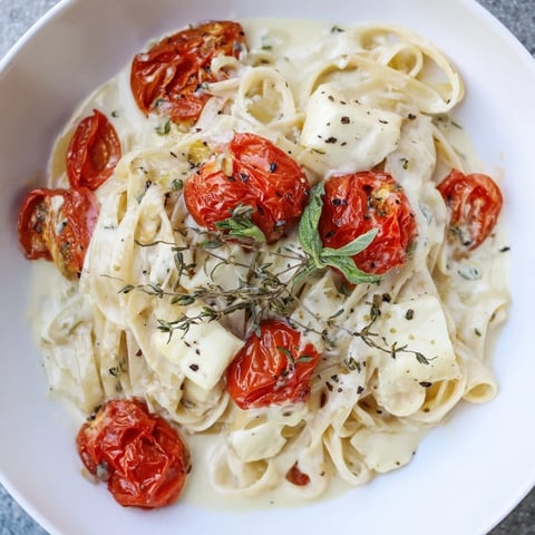 Creamy Baked Brie Pasta Sauce, with melted brie and bursting cherry tomatoes, ready to serve.