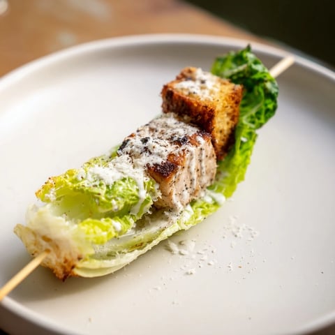 Grilled Chicken Caesar Salad Skewers served on a platter, ready to be enjoyed as a refreshing appetizer.