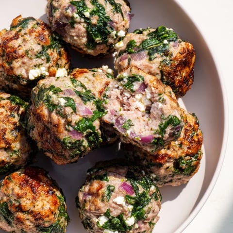 Golden-brown Spinach Feta Turkey Meatballs, tender and juicy, ready to enjoy with a fresh side salad.