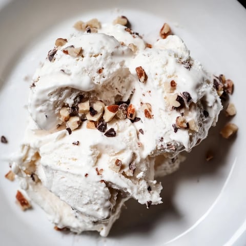 Creamy cottage cheese ice cream, swirled with fresh strawberries and ready to scoop.