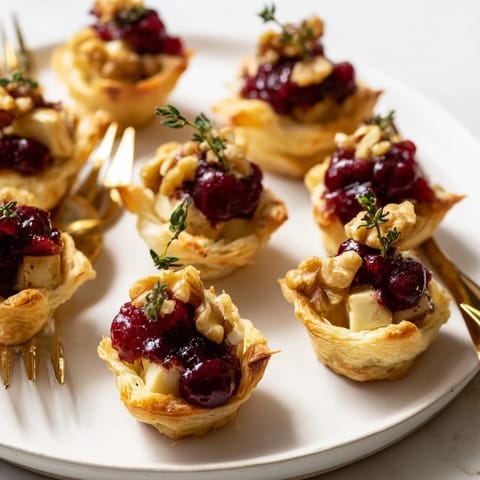 Close-up of baked Cranberry Brie Bites showcasing the creamy Brie with tart cranberry.