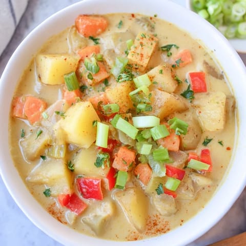 A close-up of a steaming bowl of Slow Cooker Cajun Potato Soup, perfect on a chilly evening.