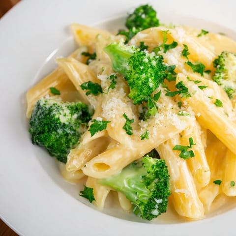 Golden Cream Cheese Garlic Pasta coated with melted Parmesan, rich and savory, ready to be devoured tonight.