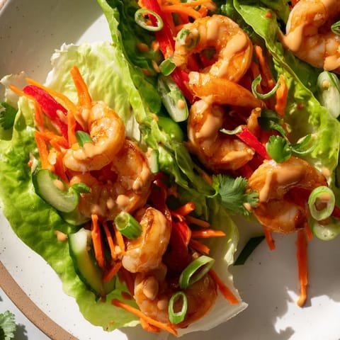 Healthy and fresh-looking shrimp lettuce cups featuring a colorful mix of ingredients, ready for a satisfying, low-carb lunch.