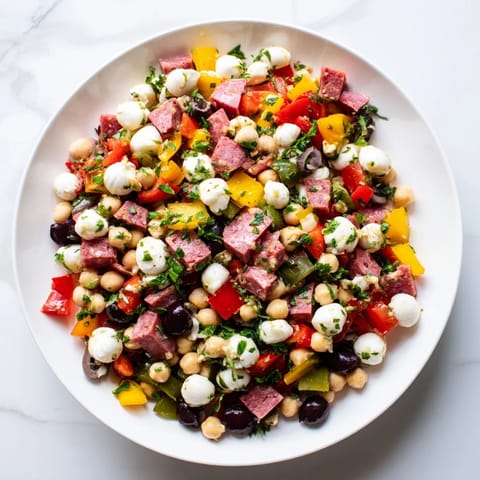 This easy Italian-American salad features crisp chickpeas, crunchy bell peppers, and savory salami, tossed with fresh herbs.