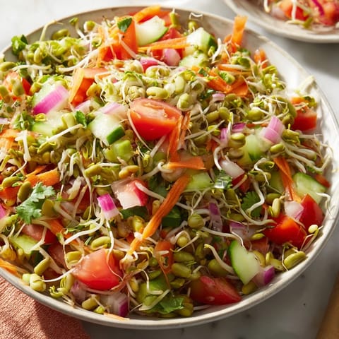 Colorful Sprouted Seed Salad topped with fresh cilantro and grated carrots, served on a white plate.  
