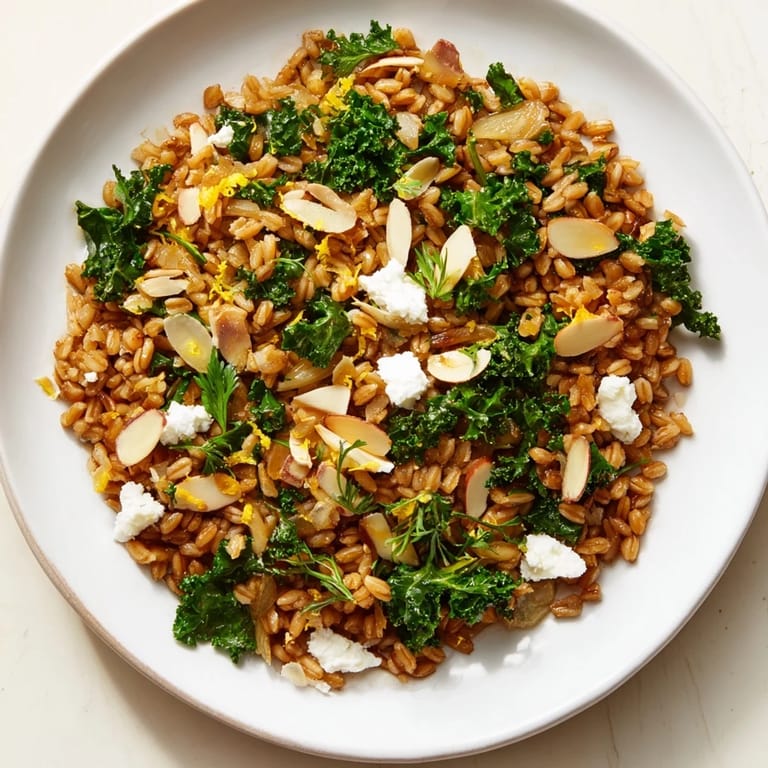 Enjoy a comforting bowl of Warm Farro & Greens Pilaf; the perfect vegetarian main course.