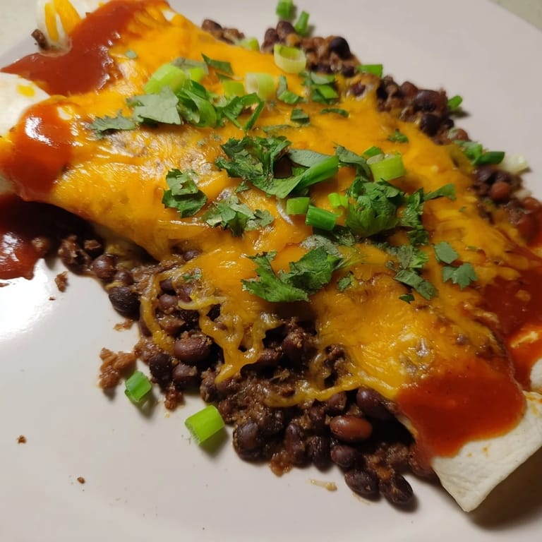 Delicious Cheesy Bean Enchiladas are baked until golden brown and ready to eat for dinner.