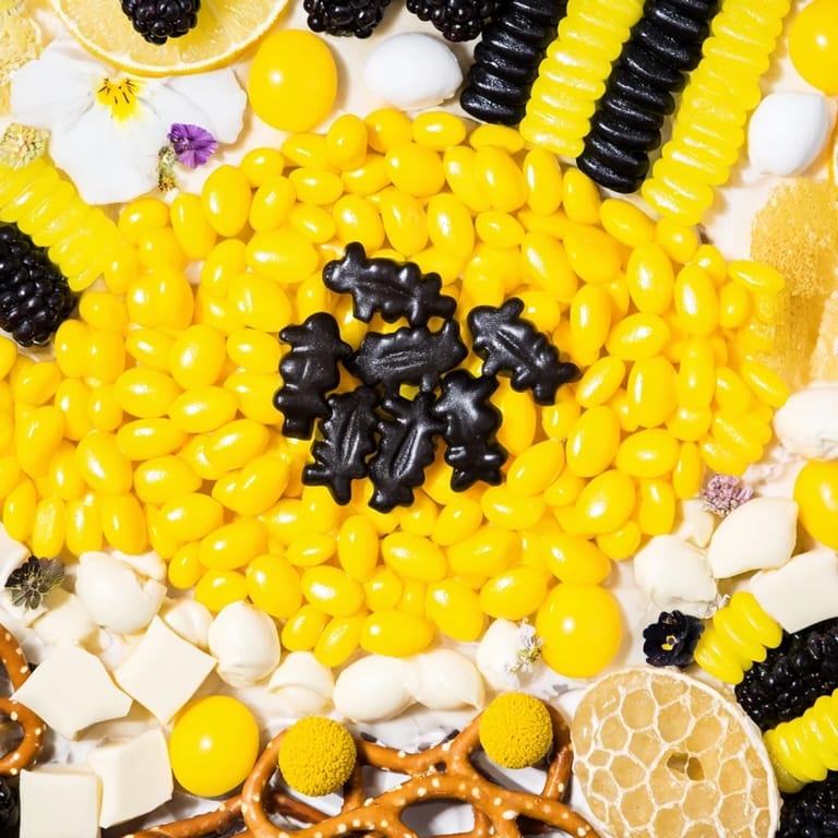 Vibrant and whimsical, this bumblebee candy board showcases a festive assortment for snacking.