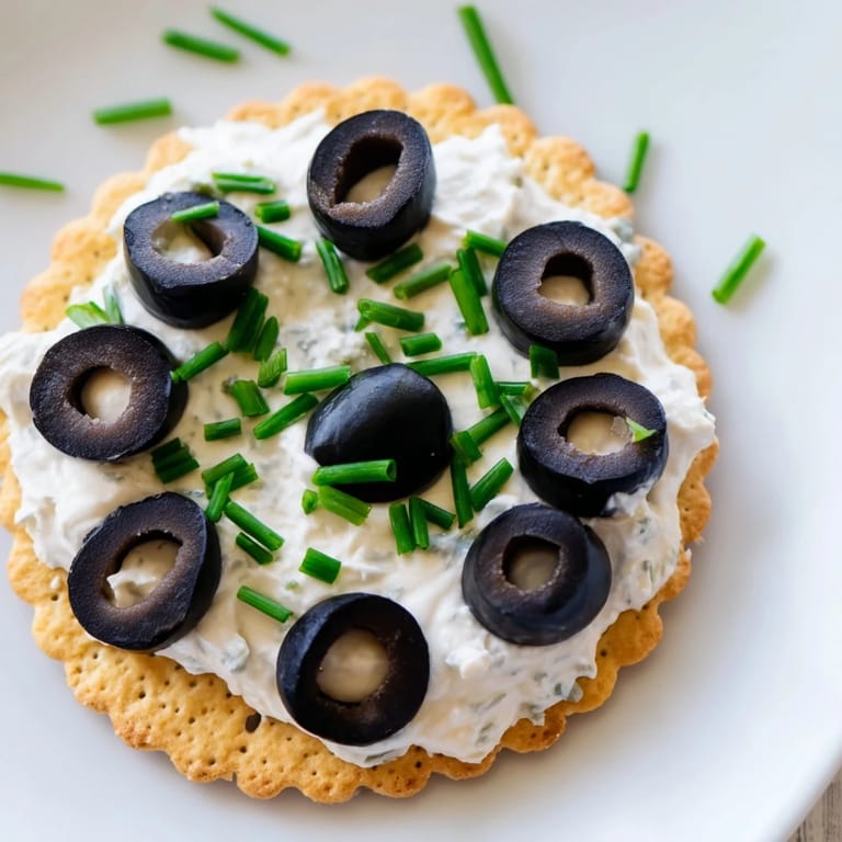 Close-up of freshly made Gold Medal Olympic Ring Appetizers featuring cream cheese and colorful vegetables.