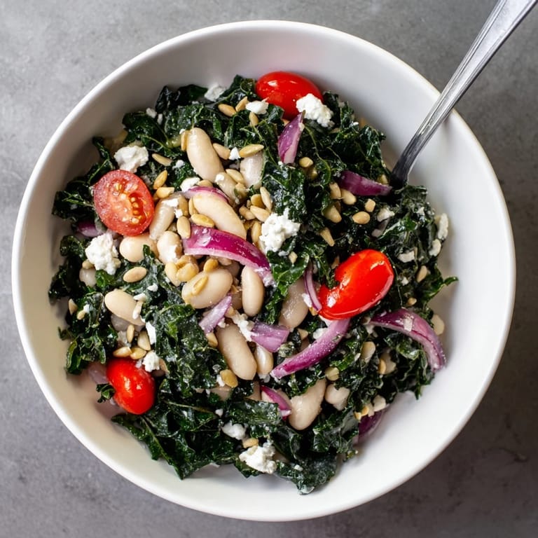 A vibrant Mediterranean White Bean and Kale Salad served in a white ceramic bowl, perfect for a healthy, vegetarian lunch or side dish.