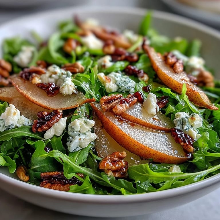 Vibrant Arugula and Pear Bowl salad with arugula greens, pears, cheese, and chopped pecans on a rustic wooden table.