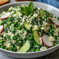 Spring Pea and Mint Couscous Salad with fresh peas and fluffy couscous, vibrant with chopped mint and parsley, drizzled in lemon-olive oil dressing.