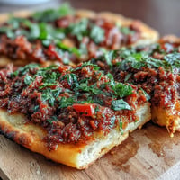 Crispy Turkish Lahmacun Pizza, topped with savory lamb, vibrant vegetables, and sumac.