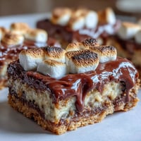 Golden-brown Pumpkin S'mores Cookie Bars with gooey melted chocolate topping.